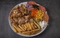 Doner kebab or gyros on a plate with french fries and salad Royalty Free Stock Photo