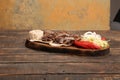 Doner kebab is lying on the cutting board. Shawarma with meat, onions, salad lies on a dark old wooden table Royalty Free Stock Photo