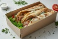 Doner kebab packaging, featuring a well-presented and appetizing kebab nestled in a to-go box, suitable for food delivery apps and Royalty Free Stock Photo