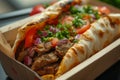 Doner kebab packaging, featuring a well-presented and appetizing kebab nestled in a to-go box, suitable for food delivery apps and Royalty Free Stock Photo