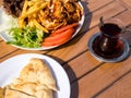 Doner kebab on the plate with french fries, tomatoes, onion and salad. Grilled chicken and lamb meat with vegetables and pita Royalty Free Stock Photo