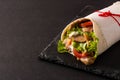 Doner kebab or shawarma sandwich on black slate background. Royalty Free Stock Photo