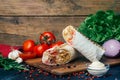 Doner kebab shawarma or doner wrap. Grilled chicken on lavash pita bread with fresh vegetables - tomatoes, green salad, Royalty Free Stock Photo