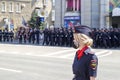 Donetsk, Donetsk People Republic - June 24, 2020: Lovely policewoman in foreground in mask from coronavirus. Police march along