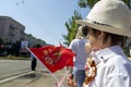 Donetsk, Donetsk People Republic, Ukraine - June 24, 2020: Young children stand with flags and await the display of armored