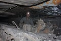 Donetsk, Ukraine - August, 16, 2013: Miner near the coal mining shearer Royalty Free Stock Photo