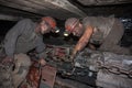 Donetsk, Ukraine - August, 16, 2013: Miners near the coal mining shearer Royalty Free Stock Photo