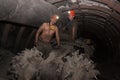 Donetsk, Ukraine - March 14, 2014: Drivers of the coal miner repairs in the underground mine