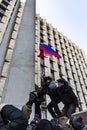 2014 DONETSK, UKRAINE - MARCH 9. The Russian Federation flag raising on the flagpole of the Donetsk regional administration. Royalty Free Stock Photo