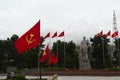 Town square with monument and communist flags