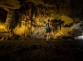 Trung Trung Cave Cat Ba Vietnam Girl Tourist admires beautiful Stalactite formations