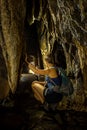 Trung Trung Cave Cat Ba Vietnam Girl Tourist admires beautiful Stalactite formations Royalty Free Stock Photo