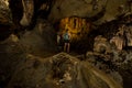 Trung Trung Cave Cat Ba Vietnam Girl Tourist admires beautiful Stalactite formations