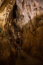 Trung Trung Cave Cat Ba Vietnam Girl Tourist admires beautiful Stalactite formations