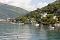 Surroundings of the city of Tivat, houses on the shore, a small beach with tourists on a quiet sunny summer day