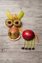 Donkey made with fruits on wooden background