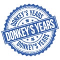 DONKEY`S YEARS text on blue round stamp sign Royalty Free Stock Photo