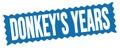 DONKEY`S YEARS text written on blue stamp sign Royalty Free Stock Photo