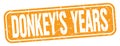 DONKEY`S YEARS text written on orange stamp sign Royalty Free Stock Photo