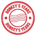 DONKEY`S YEARS text written on red round postal stamp sign Royalty Free Stock Photo