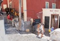 Donkeys and tourists in a small street in Santorini, Greece