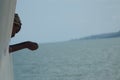 African lady looking out of ship over Lake Volta