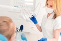 Kind female stomatologist treating teeth of teen patient