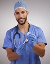 Dont be scared, its going to help. a handsome young nurse standing alone and using a syringe to prepare a Covid Royalty Free Stock Photo