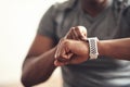 Dont fall behind, keep up the pace. Closeup shot of an unrecognisable man checking his wristwatch while exercising at