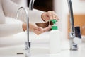 Dont forget to use soap. Shot of an unrecognizable person washing her hands with soap at home.