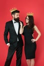 Dont go to prom alone. Prom king and queen. Sensual woman and bearded man wear prom crowns. Coronation party. Holiday