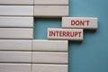 Dont interrupt symbol. Concept word Dont interrupt on wooden blocks. Beautiful grey green background. Business and Dont interrupt