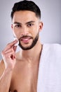 Dont just wash, care for your skin properly. a handsome young man cleaning his face with a cotton pad. Royalty Free Stock Photo