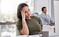 Dont let angry customers throw you off. a young call centre agent looking stressed out while working in an office. Royalty Free Stock Photo