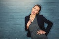 Dont let business kill your silly side. a silly businesswoman pulling a funny face while posing against a brick wall.