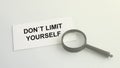 dont limit yourself word on paper and magnifying lens