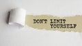 Dont limit yourself. words. text on gray paper on torn paper background