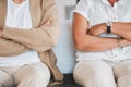 Dont look at me, its not my fault. Closeup shot of an unrecognisable couple sitting with their arms crossed during an