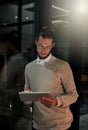 Dont look at the time, just get the job done. a handsome young designer working late in the office. Royalty Free Stock Photo