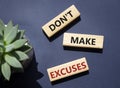 Dont make excuses symbol. Concept word Dont make excuses on wooden blocks. Beautiful deep blue background. Business and Dont make