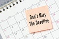 Dont miss the deadline text on sticky note on a calendar. Royalty Free Stock Photo