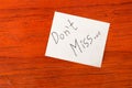 Dont Miss - Post it Note on Wood Background Royalty Free Stock Photo