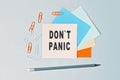 DonT Panic - text on sticky note paper on gray background. Closeup of a personal agenda. Top view Royalty Free Stock Photo