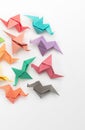 Dont see the paper, see the possibility. Studio shot of a pile of colourful origami birds.