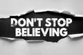 DONT STOP BELIEVING message displayed under torn paper concept symbolizing hope, perseverance, and motivation, ideal for Royalty Free Stock Photo