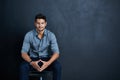 Dont stop until victory is yours. Studio portrait of a confident young businessman posing against a dark background. Royalty Free Stock Photo