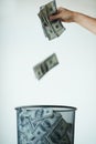 Dont throw your life savings away - Bank. Someone throwing money away in a trash can. Royalty Free Stock Photo