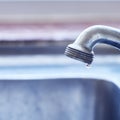 We dont want to run on empty. Closeup of a dripping tap waisting a little bit of water in a basin inside of a house Royalty Free Stock Photo