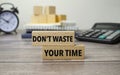 dont waste your time is shown on a conceptual photo using wooden blocks