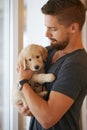 Dont worry Ill keep you safe. Cropped shot of a young man holding a puppy. Royalty Free Stock Photo